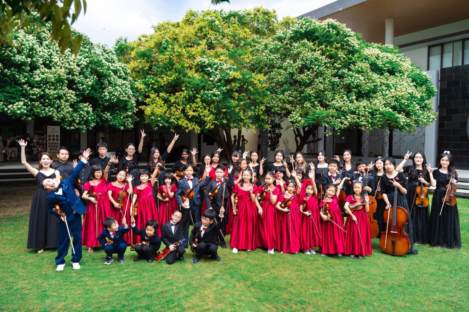 Claviera students and musicians gathered outdoors after a community performance.